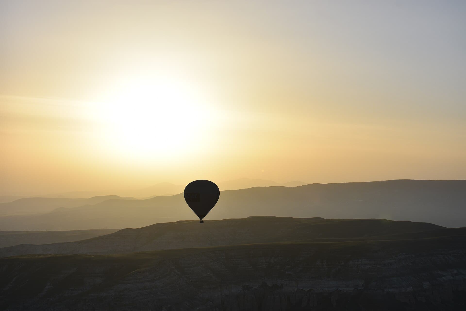 A hot air balloon over Cappadocia at sunrise